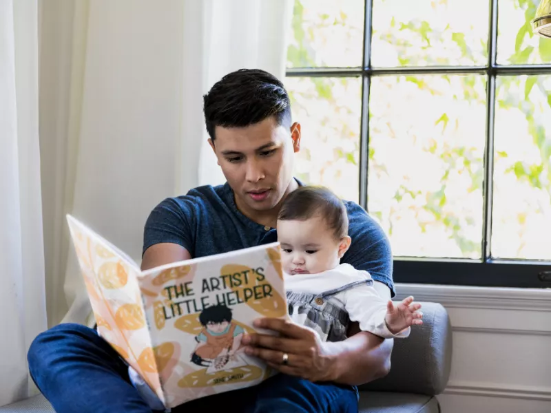 dad reading book to baby