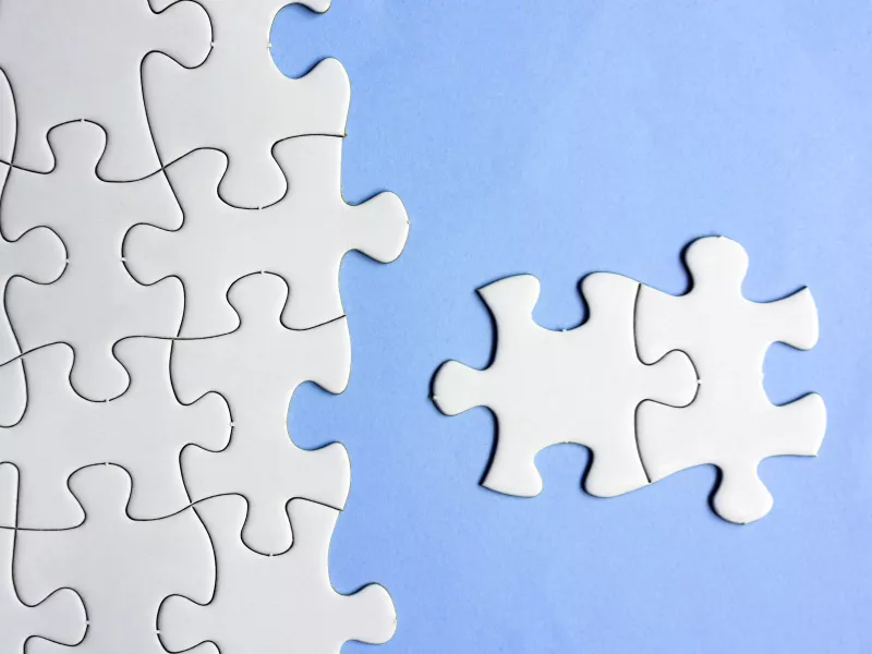 white jigsaw pieces on blue background